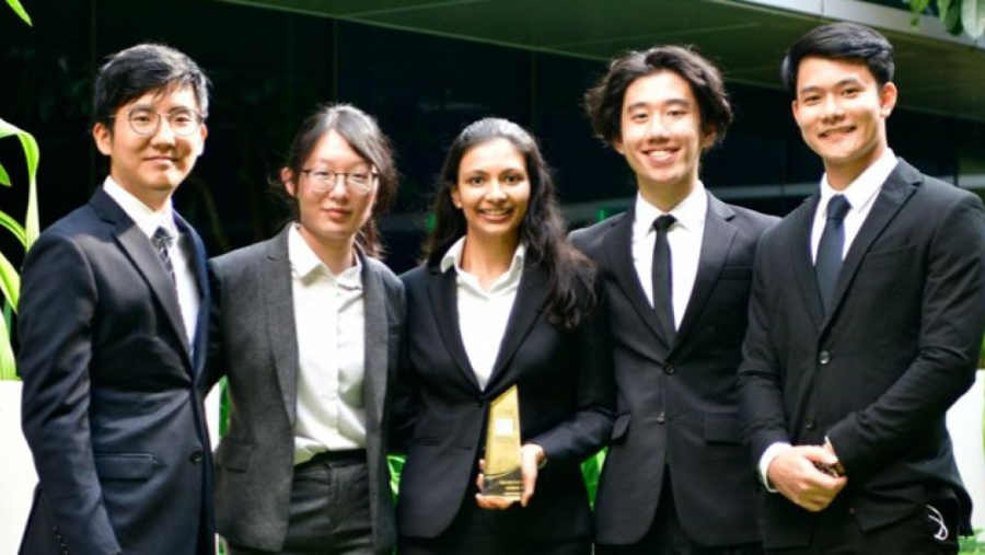 Juhi (centre) and her team mates after winning a moot competition