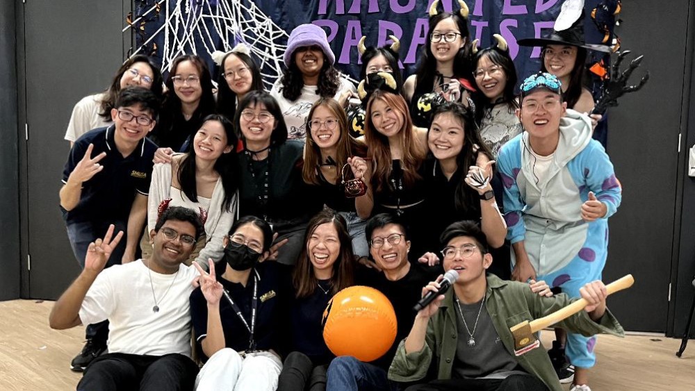 Andrew (front row, 2nd from right) with his SMU Studentsâ Association (SMUSA) teammates at its Halloween event in 2022