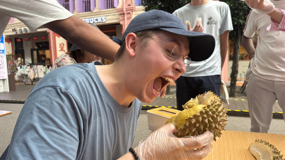 Sven trying durian, Singaporeâs âking of fruitsâ. 