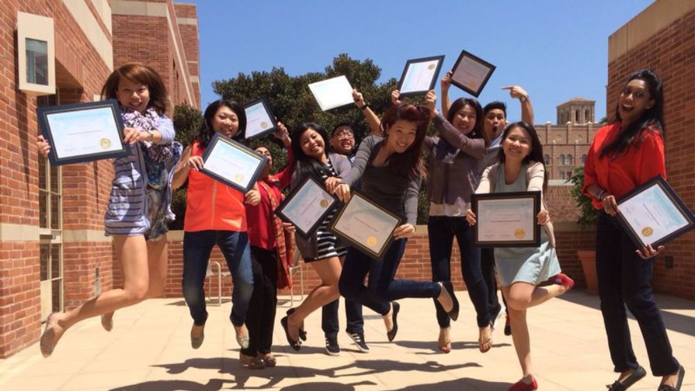 Trang and classmates doing the SMU jump with their UCLA certificates