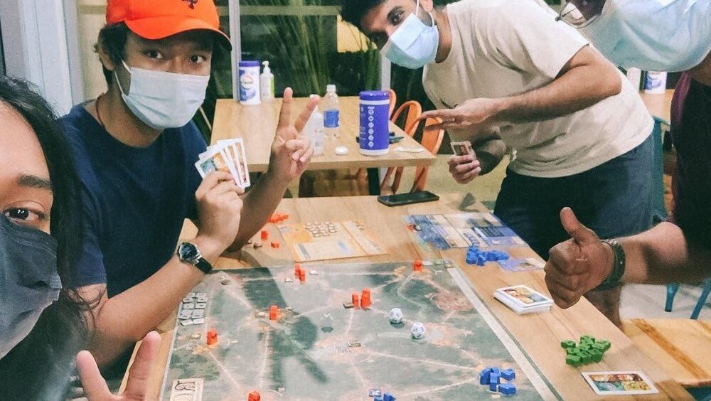 Caption: Uday engaging with fellow PSR residents through a game of Risk