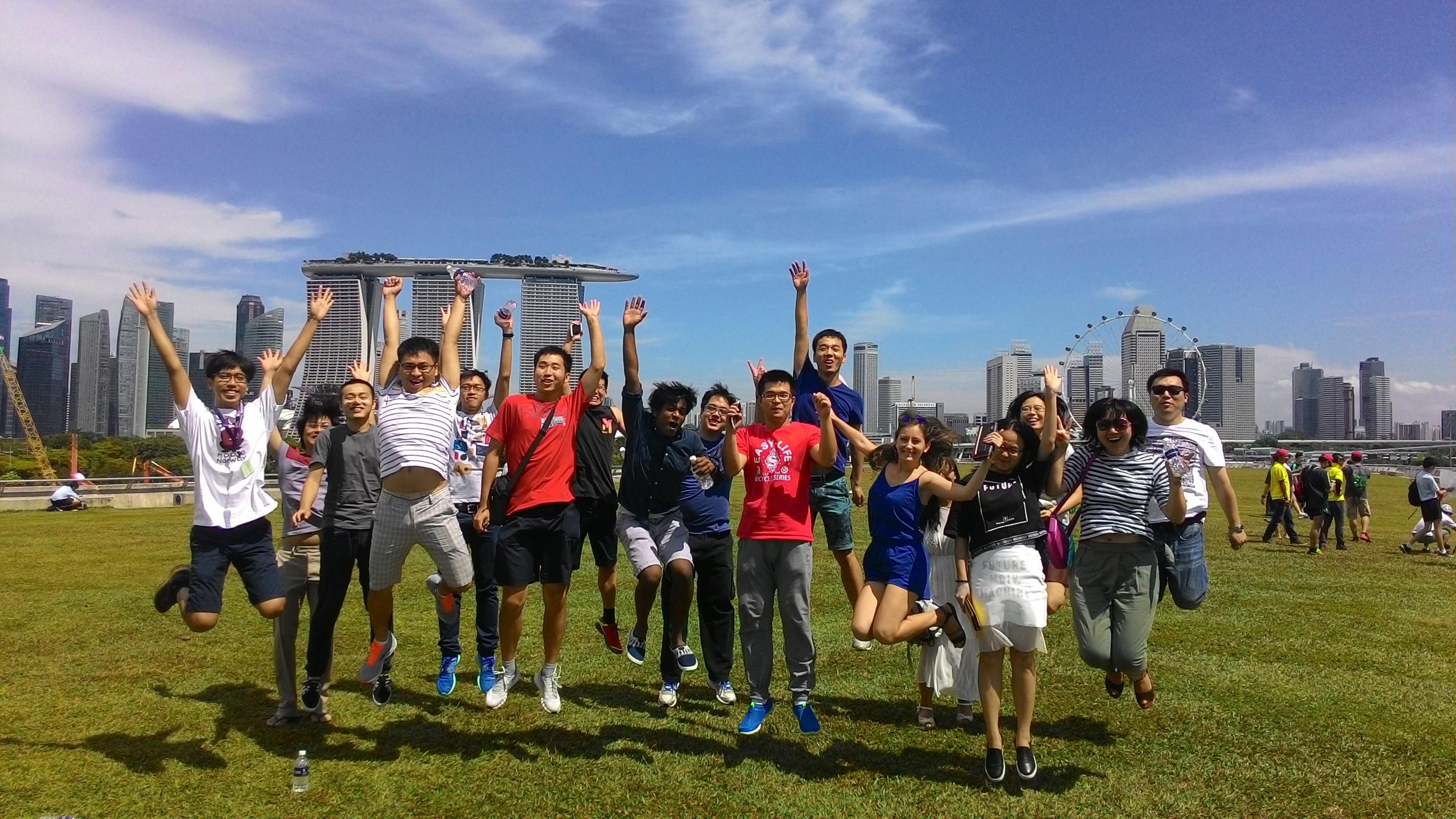 1st year SMU PhD students try out the signature SMU Jump against the Singapore city skyline