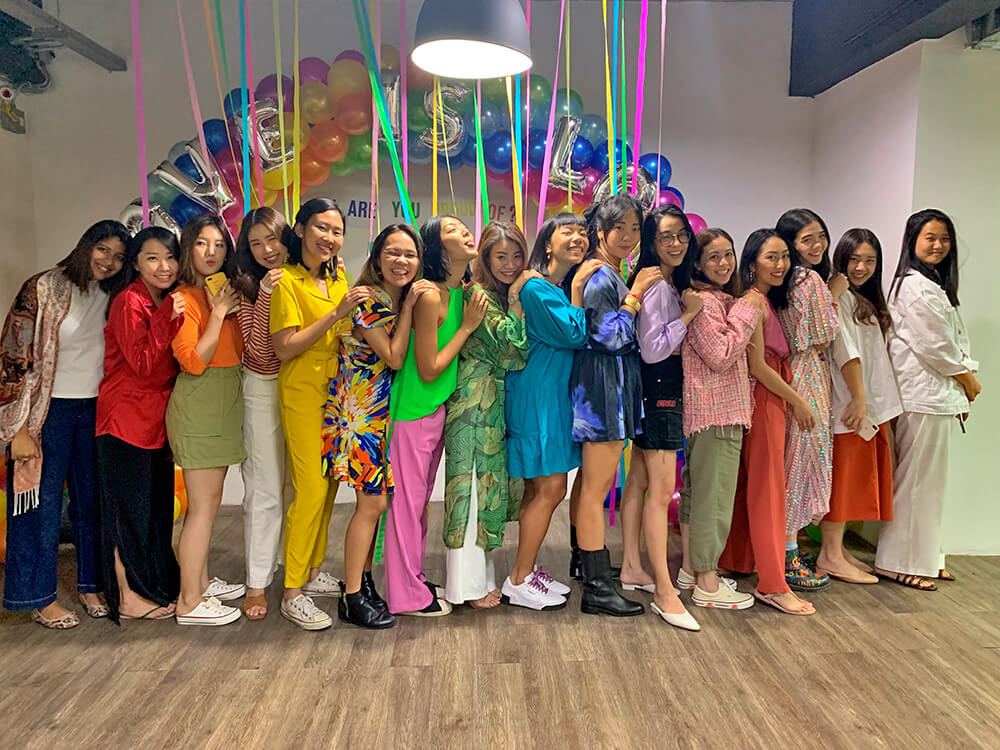 Pomelo employees forming rainbow colours during Pride Month celebrations